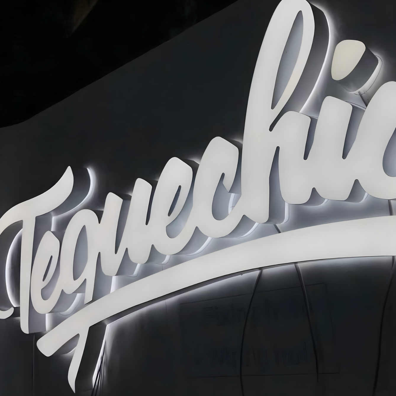 Luxury trimless dual-lit storefront sign with soft halo illumination
