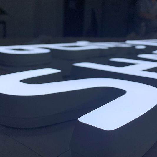 Luxury trimless front-lit LED channel letters on boutique storefront