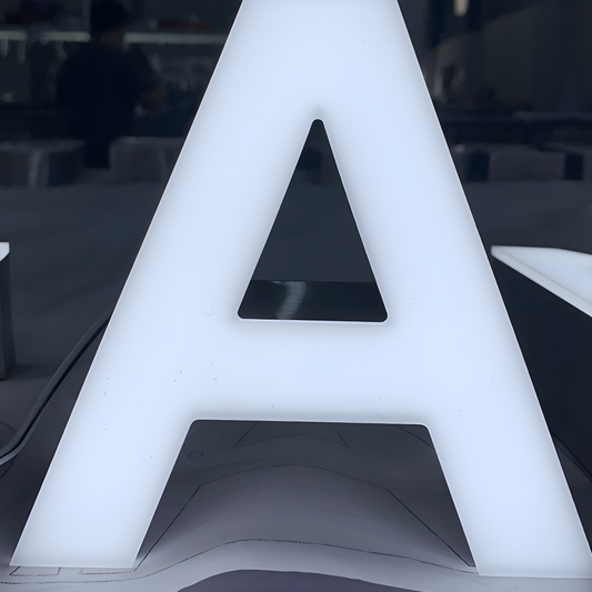 Premium trimless front-lit LED letters glowing on outdoor wall