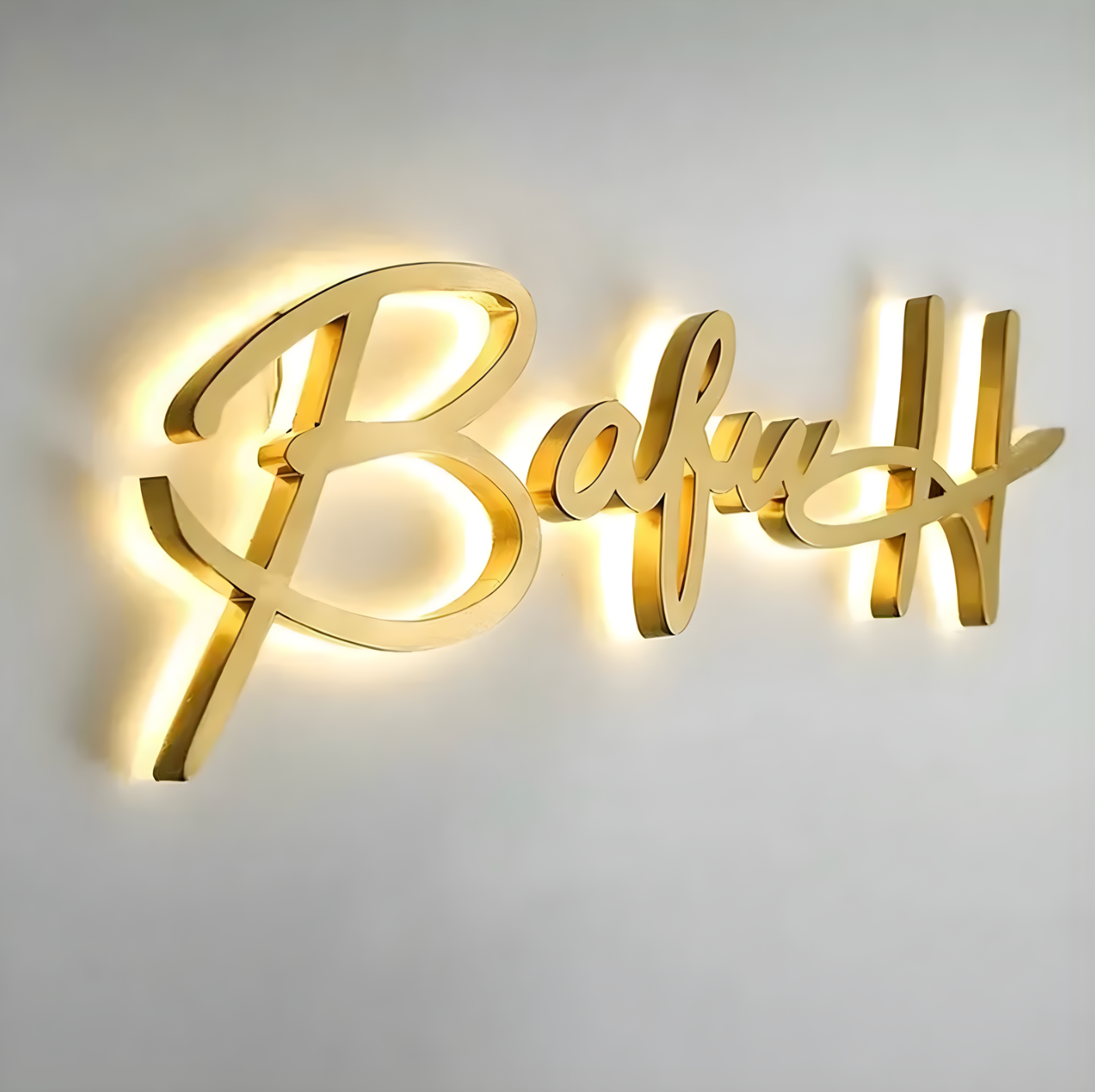 interior lobby sign with reverse-lit stainless letters and soft halo glow