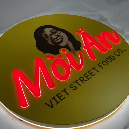 Bold illuminated push-through sign with raised acrylic graphics