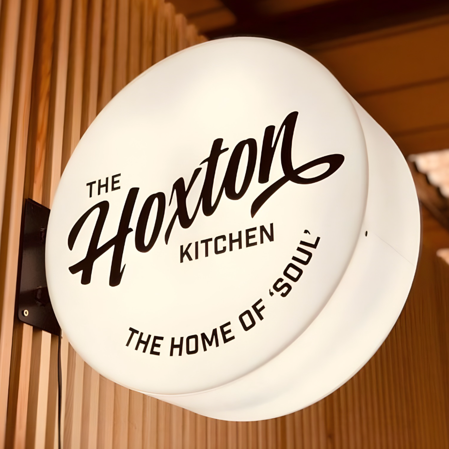 Custom illuminated trim-cap blade sign for exterior brand identity